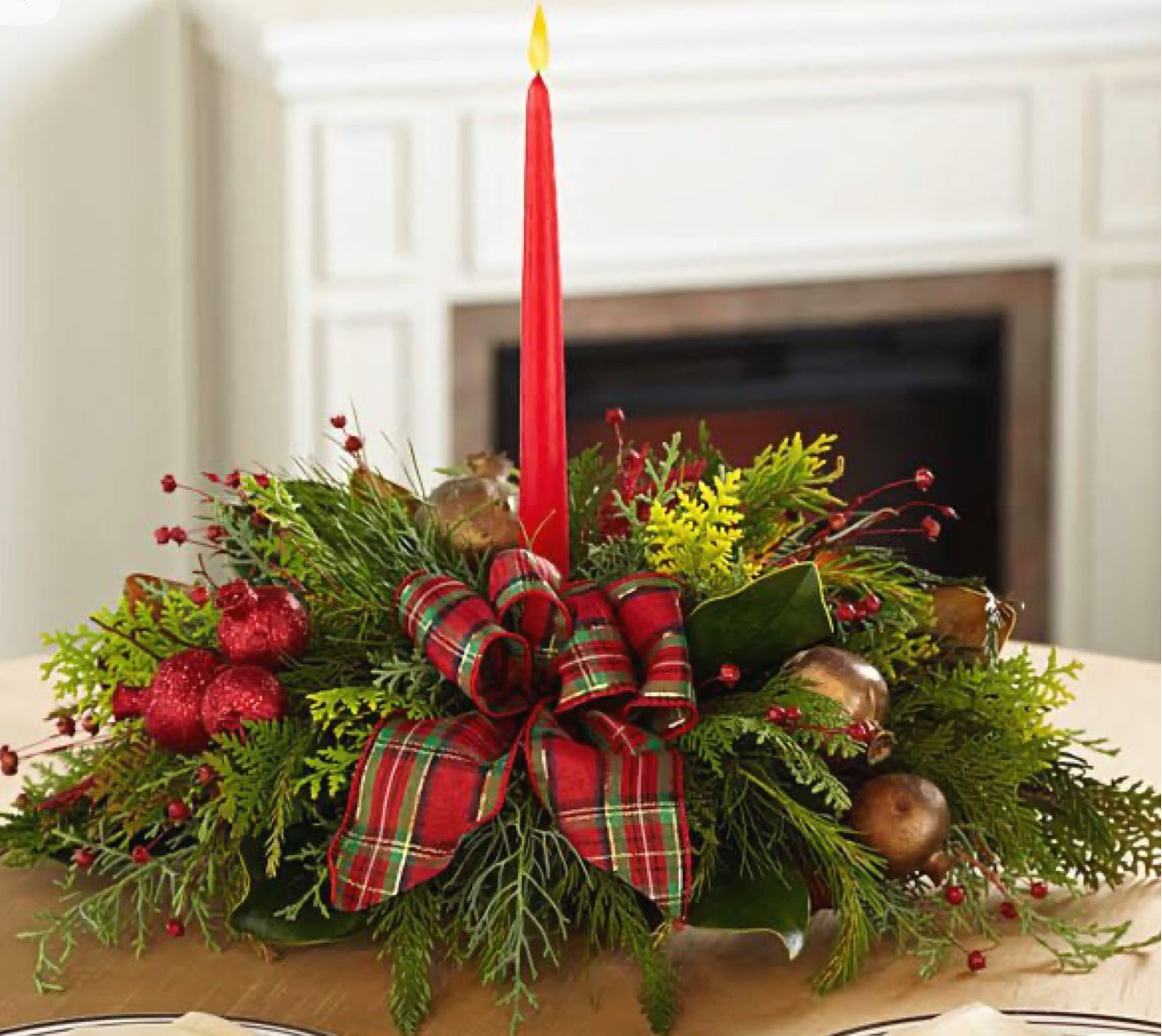 Red and white Christmas floral arrangement with seasonal greenery and festive accents