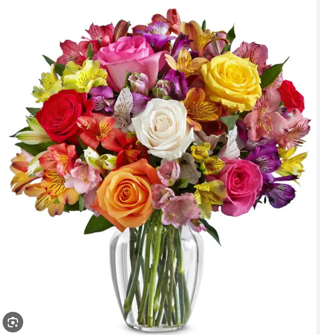 Bouquet of colorful flowers in a clear vase on a white background