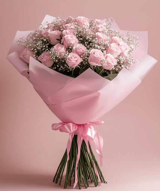 Soft pink rose bouquet with baby’s breath wrapped in pastel paper and satin ribbon – Blush Whisper Bouquet by 1800 Blooms Bronx NY