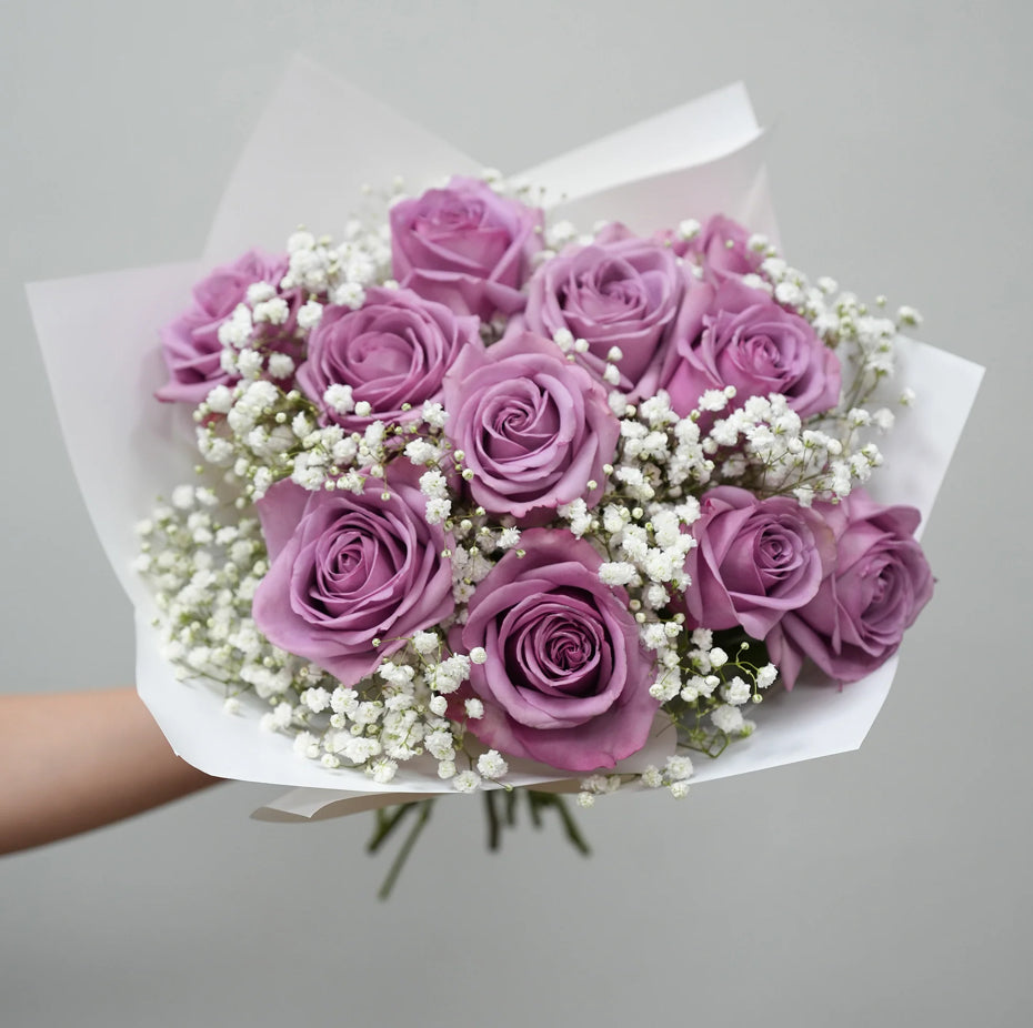 Lavender rose bouquet with baby’s breath wrapped in white paper – Enchanted Lilac Bouquet by 1800 Blooms Bronx NY