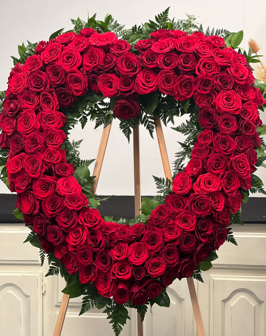 Heart-shaped arrangement made of red roses with fresh greenery, symbolizing eternal love and remembrance – Eternal Rose Heart by 1800 Blooms Bronx NY