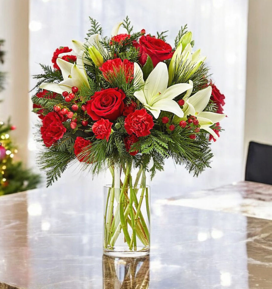Hand-tied Christmas bouquet with red roses, white flowers, pine and holiday decoration