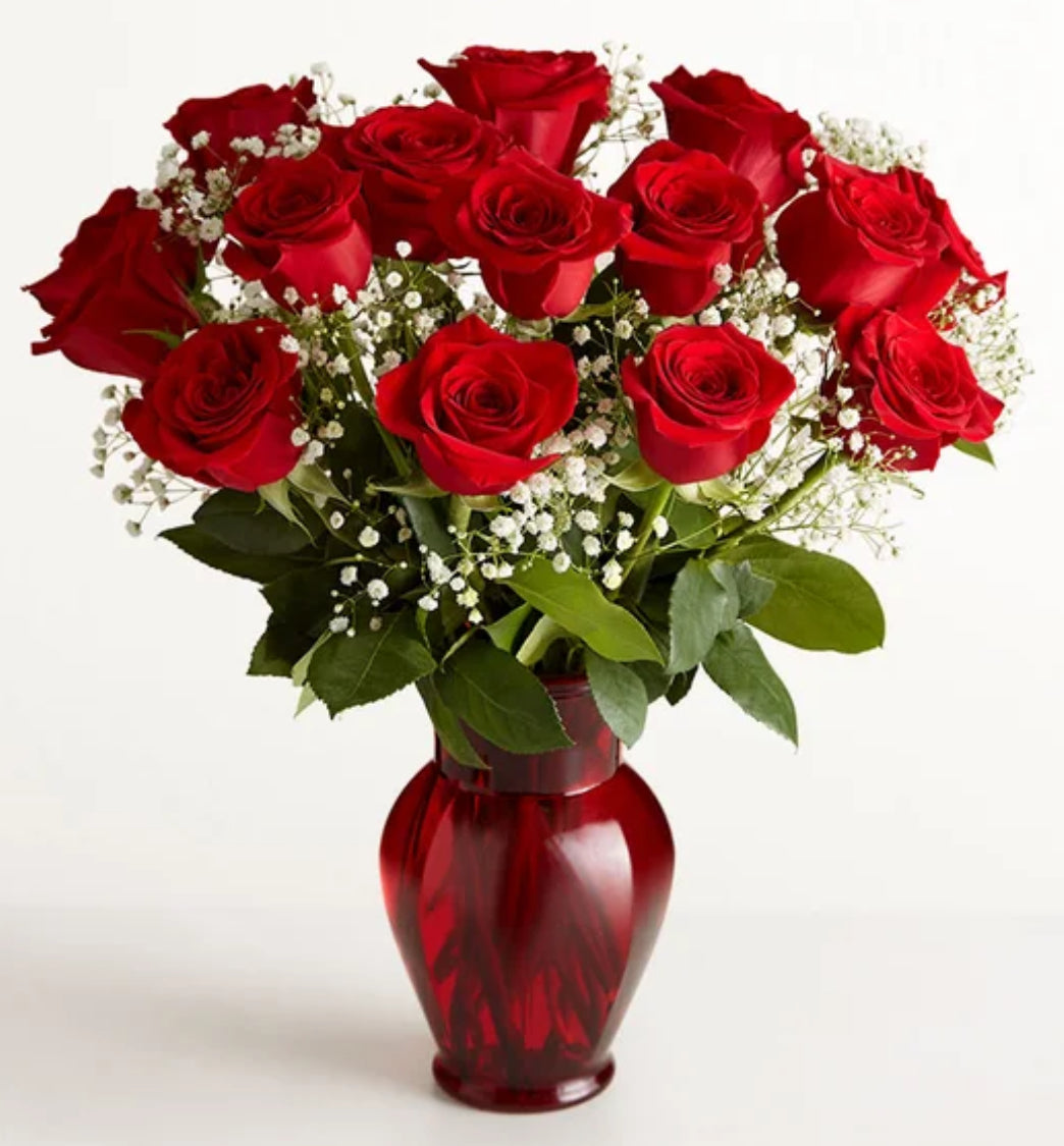 Bouquet of red roses in a red vase on a white background