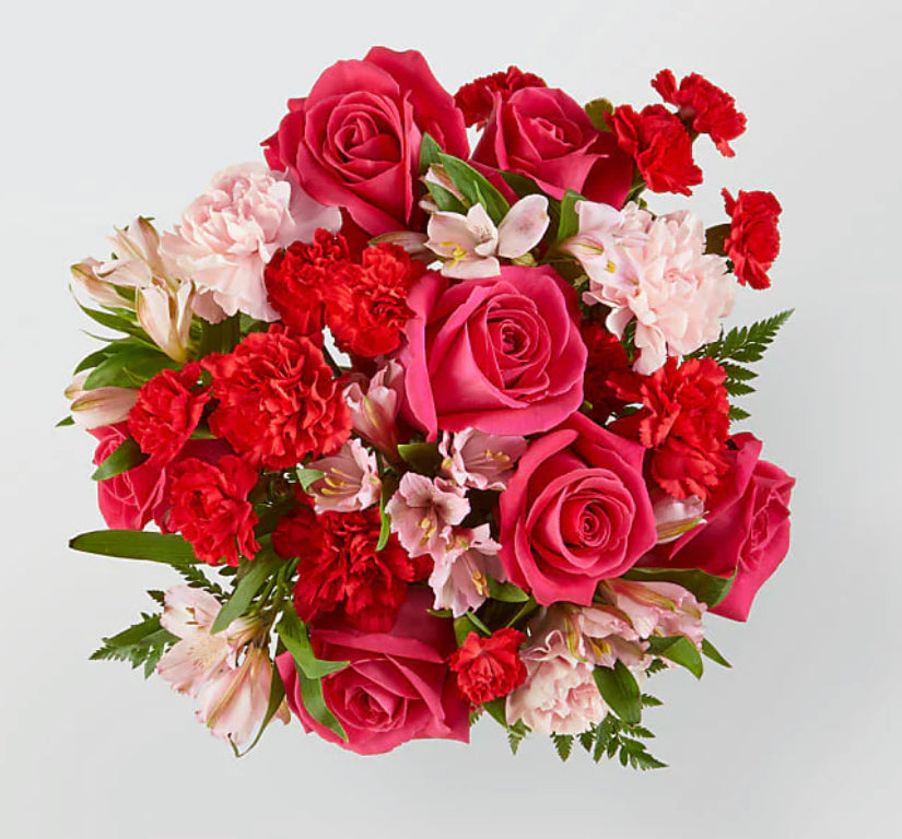 Bouquet of red and pink flowers on a light gray background